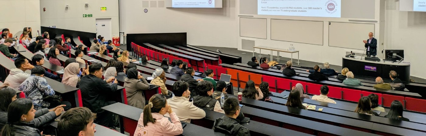 Group of people sitting in a lecture theatre.