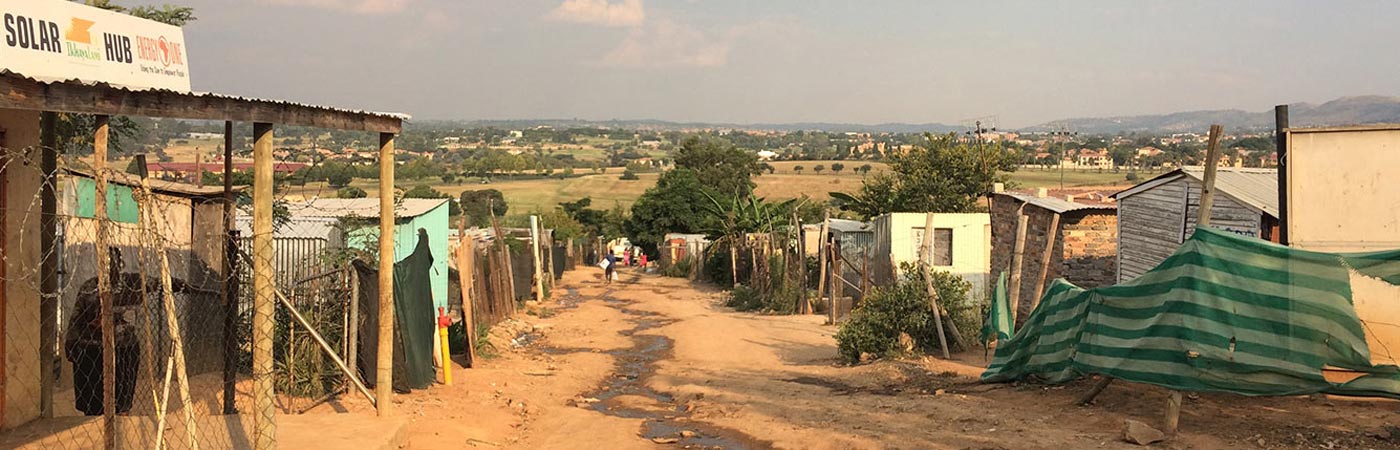 Dirt road through an underdeveloped village.